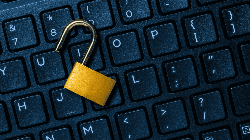 Computer keyboard with an unlocked padlock showing compromised cybersecurity and how Huntress can help